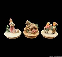 Front view of all three resin Christmas candle toppers