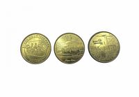 Obverse sides of three brass tokens showing distinct Stone Mountain Park designs