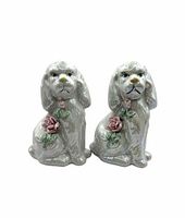 Front view of both lustreware spaniel figurines showing iridescent glaze and rose details