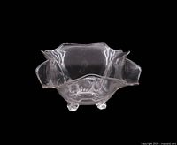 Front view of clear ruffled footed bowl showing scalloped rim and overall form