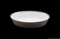 Top/side view showing mint band and silver trim on white porcelain bowl