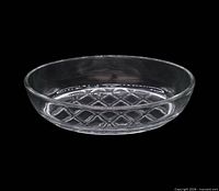 Side view of oval clear glass dish showing smooth walls and interior waffle pattern on base