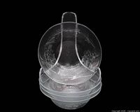 Four pressed glass bowls stacked, showing exterior and fruit pattern