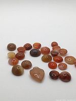 Group of agate cabochons laid out on white background