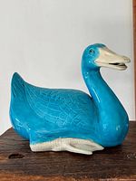Left side view of turquoise porcelain duck showing feather pattern and coloration