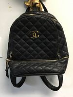 Front view showing quilted texture, CC logo, front pocket zipper