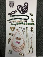 Full overhead view of all costume jewelry items laid out on white background