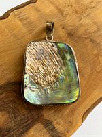 Front view of abalone pendant showing shell and sterling bezel