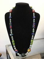 Full view of beaded necklace on display form