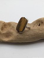 Front view showing tiger's eye cabochon in silver bezel