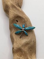 Front view of dragonfly brooch showing turquoise inlay