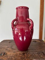 Front view of burgundy four-handle vase