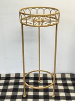 Full view of yellow metal plant stand showing overall form and color
