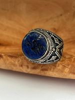 Front view of silver ring showing carved lapis lazuli intaglio face