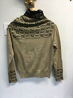 Full back view of beige logo sweater on hanger