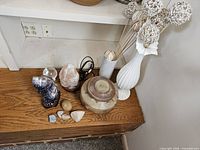 Entire lot on shelf: vase with stems, geode, salt lamp, crystal sphere, pottery jar, assorted stones