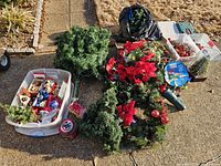 overview of wreaths, ornaments, LED light spool, storage tote