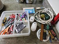 Overview of entire lot on countertop showing organizer tray with tools and cords alongside