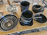 All cookware grouped on table showing variety and quantity