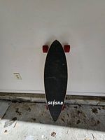 Top view of longboard showing grip tape and SC/SK8 logo