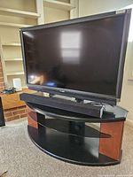 Sharp 52" LCD TV on stand with soundbar visible