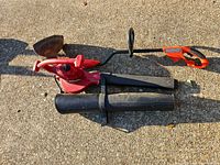 Overall view of Toro blower-vac body, two black tubes and integral cord