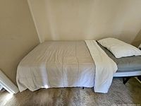 Full view of folded-out twin bed with bedding