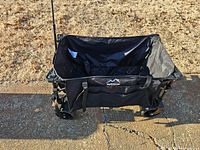 Overall view of black uyittAur collapsible wagon showing fabric bed, handle, wheels