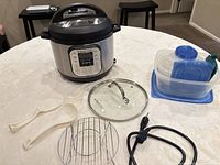 Instant Pot with accessories and Gladware containers displayed on table
