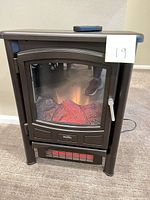 Front view of Duraflame electric fireplace heater displaying flame effect