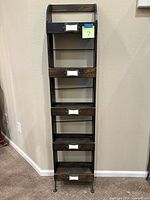 Front view of tall narrow five-shelf unit