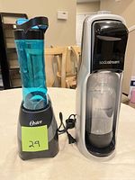 Front view showing SodaStream machine with bottle and Oster blender with bottle