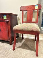 Front view of cherrywood side chair beside cabinet