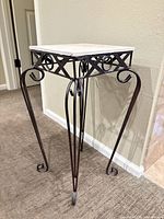 Full view of metal side table showing overall design and legs
