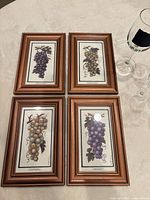 Overview of four framed grape prints and glassware