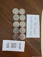 All ten coins laid out beside note showing count and years