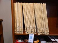 All 19 volumes aligned on bookshelf, spines visible