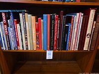 Full shelf of large hardcover books