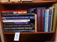 Front view shelf with horizontally stacked and vertically aligned coffee table books