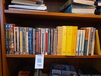 Shelf view showing entire row of approximately 30 French paperback books