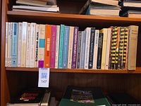 Entire shelf showing full lot of books and pamphlets
