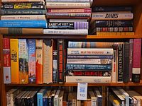 Full shelf of war-related books, multiple visible titles