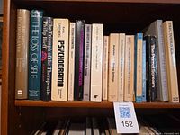 Shelf view of all seventeen psychoanalysis books showing spines and titles