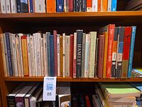 Shelf with approximately 40 Shakespeare books, titles visible on spines