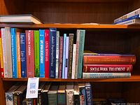 Row of vertical textbooks on sociology and social work