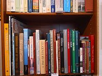 Shelf of assorted hardcover travel books showing spines and titles