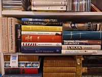 Shelf of approximately 10 biography and memoir hardcovers, titles visible as listed