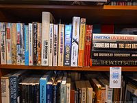 Shelf of war-themed books showing titles and authors
