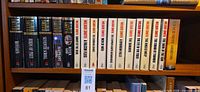 Row of Wilbur Smith paperback novels on shelf showing titles and condition