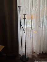 Full view of tall black metal candle holder stand